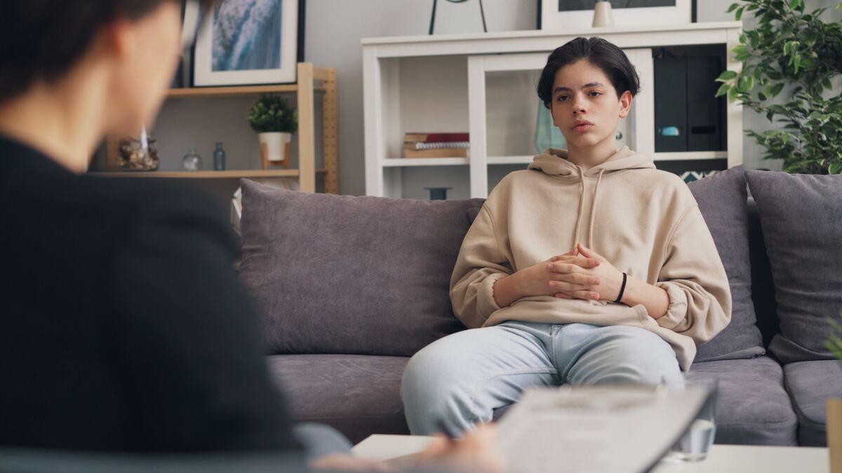 A client sitting back and reflecting during a counselling session